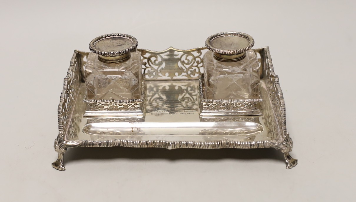 A George V pierced silver rectangular inkstand, with two mounted glass bottles and pen recess, Goldsmiths & Silversmiths Co Ltd, London, 1925, 19.5cm, 12.7oz.